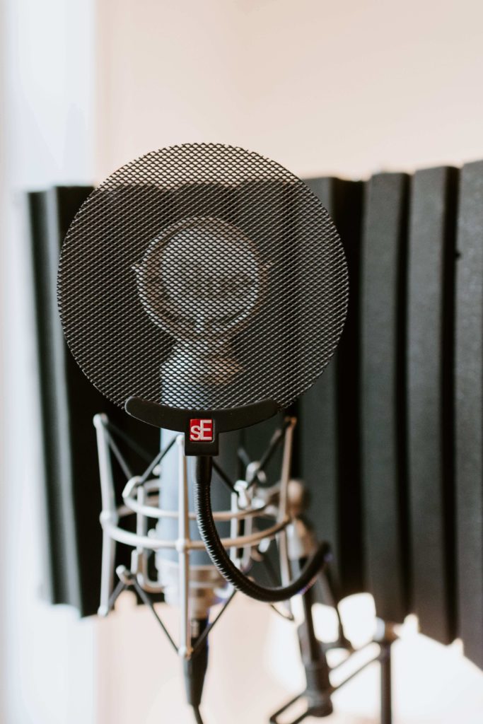 Pop filter hooked to microphone. Pop filters help you get the best sound quality for YouTube videos, music, and ADR audio in film.