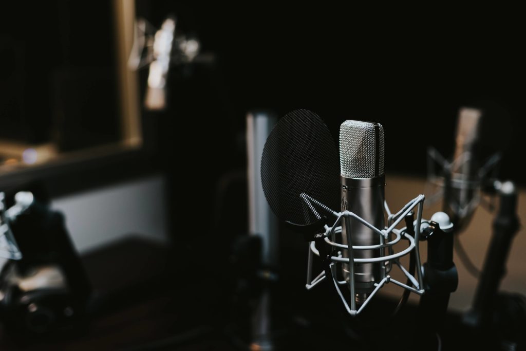 Recording studio with mic & pop filter. Having the right recording space really improves sound quality on YouTube videos.